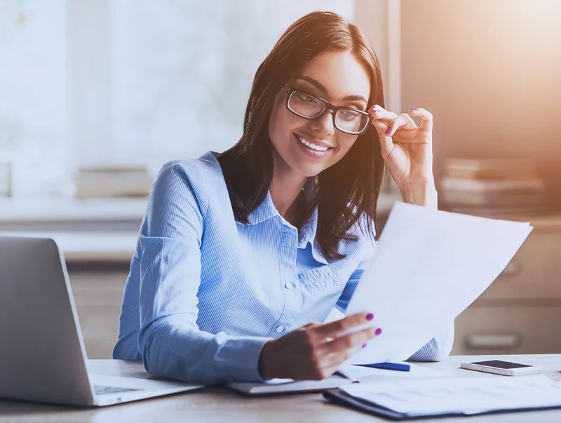 A young woman proofreads while working from home